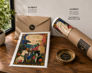 Art print of greyhounds, envelope, and cylindrical packaging on a wooden surface.