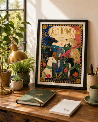 Decorative poster of greyhounds on a wooden desk with plants and a lamp.