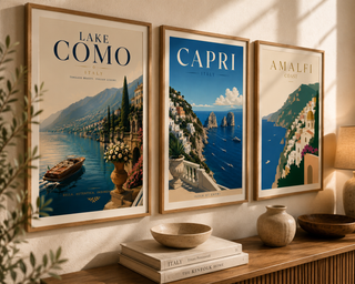 Three framed posters of Lake Como, Capri, and Amalfi on a wall with decorative items below.